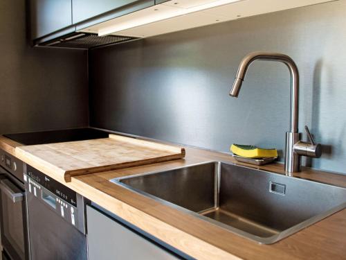 a kitchen with a stainless steel sink and a counter at Chalet Henri by Interhome in Moleson