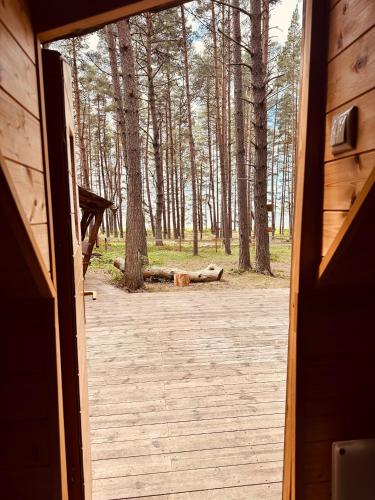 an open door of a cabin with trees in the background at Hosby Päkapikumaja Vormsi saarel in Hosby