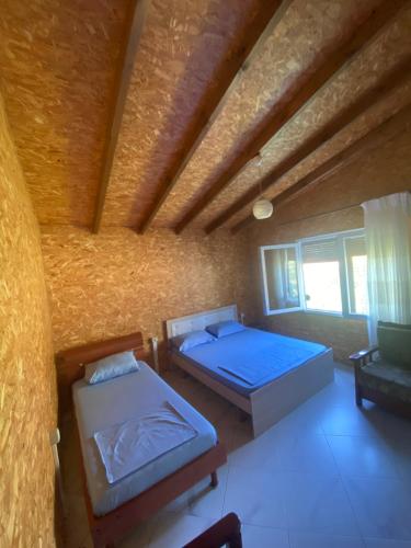 a room with two beds and a couch in it at Villa Ajla in Borsh