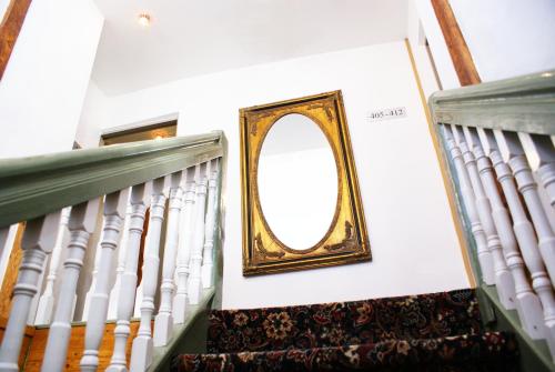a mirror on the wall next to a staircase at Gotthard Residents in Tallinn