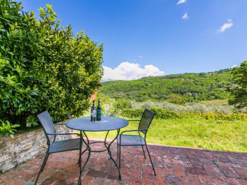 a table and chairs on a brick patio with a view at Apartment Lavanda by Interhome in Lucolena in Chianti