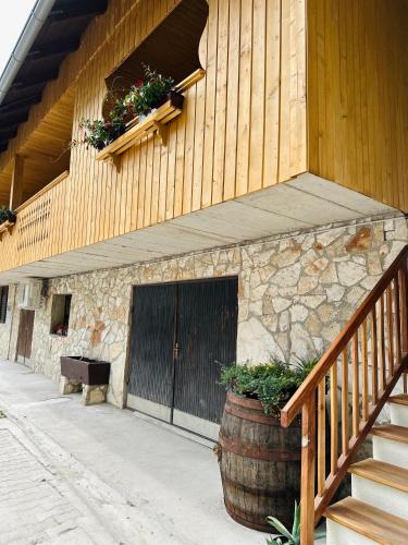 a building with a staircase and a door and a barrel at Stara Žaga in Bled
