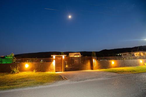 a house at night with the moon in the sky at V la vie in Ioannina