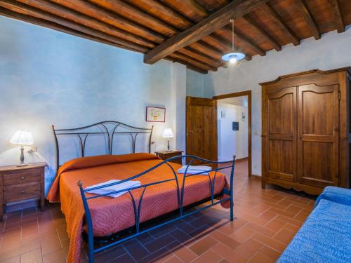 a bedroom with a bed and a wooden ceiling at Apartment Lavanda by Interhome in Lucolena in Chianti