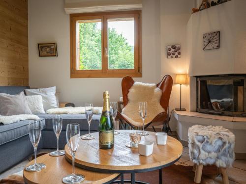 a living room with a table with wine glasses at Chalet Dendron by Interhome in Ovronnaz