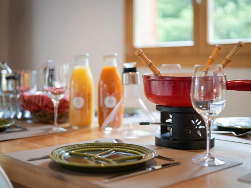 a table with plates and glasses on a table at Chalet Dendron by Interhome in Ovronnaz