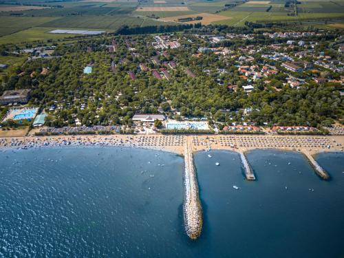 an aerial view of a beach with a pier in the water at Villaggio San Francesco - Adria Holiday Mobile Homes in Duna Verde