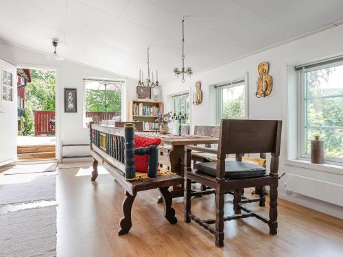 a dining room with a wooden table and chairs at Holiday Home Sjödrömmen by Interhome in Näsviken