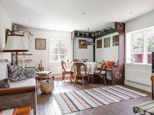 a living room with a table and chairs at Holiday Home Sjödrömmen by Interhome in Näsviken