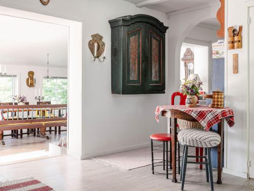 a dining room with a green cabinet and a table at Holiday Home Sjödrömmen by Interhome in Näsviken