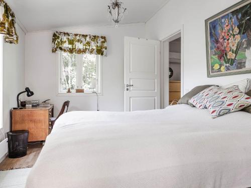 a bedroom with a white bed and a window at Holiday Home Sjödrömmen by Interhome in Näsviken