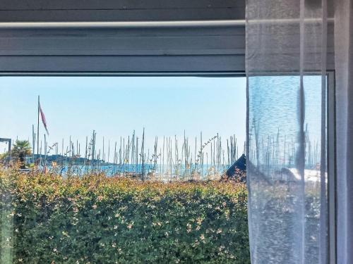 a window with a view of a harbor with sailboats at Apartment Les Voiles by Interhome in La Trinité-sur-Mer