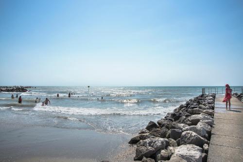 a group of people in the water at the beach at Villaggio San Francesco - Adria Holiday Mobile Homes in Duna Verde