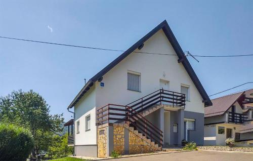 a white house with stairs on the side of it at 4 Bedroom Nice Home In Smoljanac in Smoljanac