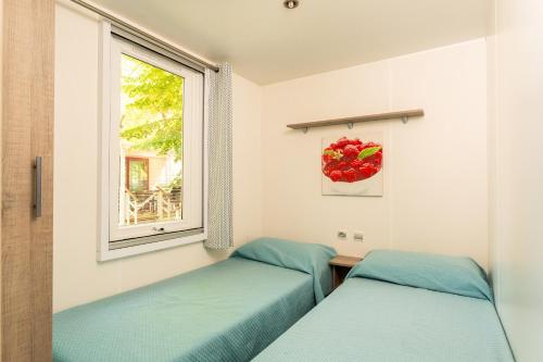Postel nebo postele na pokoji v ubytování Villaggio San Francesco - Adria Holiday Mobile Homes