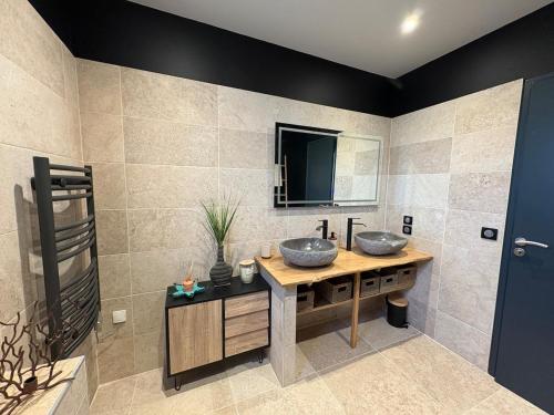 a bathroom with two sinks and a mirror at La casa bella vista in Enval