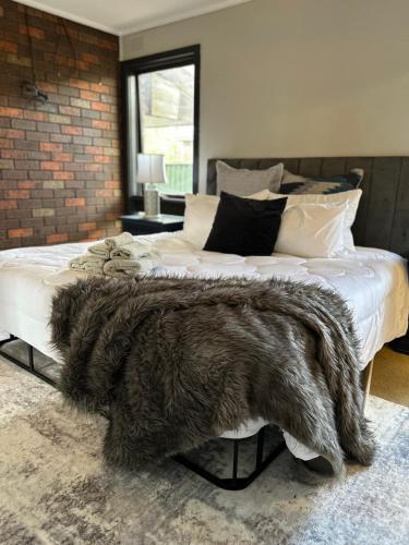 a bedroom with a bed with a furry blanket on it at 3 Bdrm home,pool, BBQ , fireplace Great for a weekend of fun or family retreat in Croydon