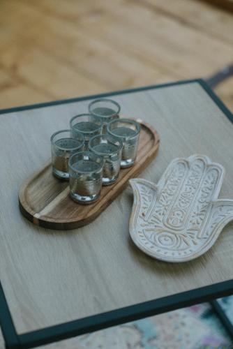 a tray of glasses and a plate on a table at Sve Mir in Boljevac