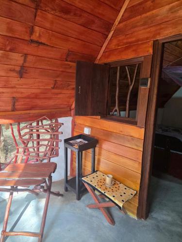 a room with a table and a chair and a table and a stool at Relax Nature Villa in Sigiriya