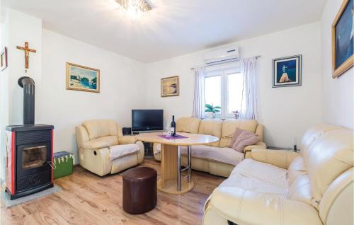a living room with a table and a fireplace at Beautiful Home In Jurdani With Wifi in Jurdani