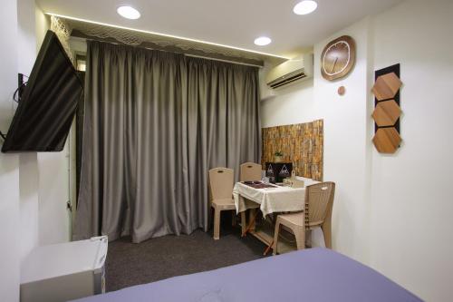 a room with a table and chairs and a bed at Stay & Go room in Shkodër