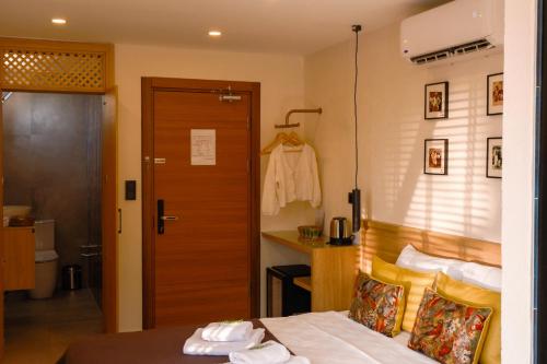 a room with a bed and a door and a room with at Uva Rooms in Fethiye