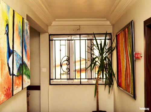 a window in a room with paintings on the wall at Prince Of Anthony 1960 Hotel-apartment in Lagos