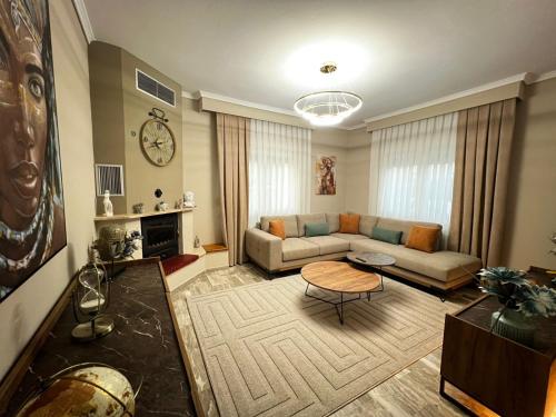 a living room with a couch and a table at Modern Makri in Mákri