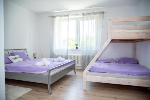 a bedroom with two bunk beds and a window at ApartHome 