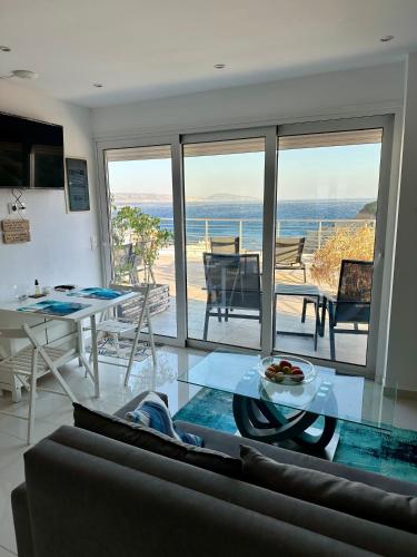 a living room with a view of the ocean at Kim Penthouse Apartment in Agia Galini