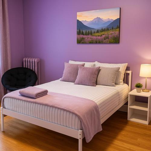 a purple bedroom with a bed and a chair at Lavender style Room in Geusthouse in New York