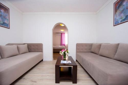 a living room with two couches and a coffee table at Rama Residence in Budva