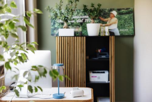 a desk with a computer and a tv on a shelf at Casa Ferretti di Ferretti Village in Silvi Marina