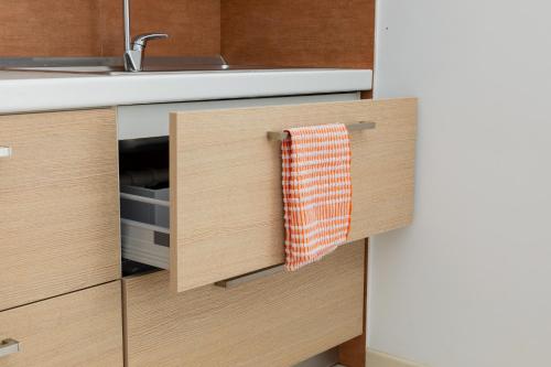 a kitchen with a sink and a towel hanging from a drawer at Boomerang Village in Torre Colimena