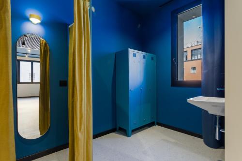 a blue bathroom with a mirror and a sink at CX Naples Centrale in Naples
