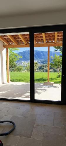 an open glass door with a view of a patio at Silenza B&B, Charme, Comfort e Relax nel Gargano in Mattinata