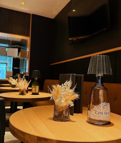 a table with a bottle of gin on top of it at Rügen-Hotel in Sassnitz