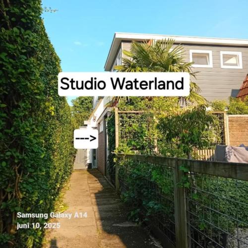 a sign that reads studio waterland next to a fence at Studio Waterland in Ooltgensplaat