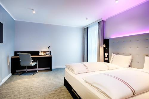 a bedroom with a large bed and a desk at Premier Inn Lübeck City Centre in Lübeck
