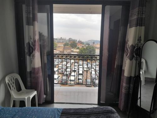 a bedroom with a window with a view of a balcony at City View Apartment, Albert Cook Road in Kampala