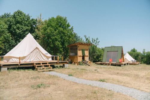 a group of tents in a field with trees at Sve Mir in Boljevac