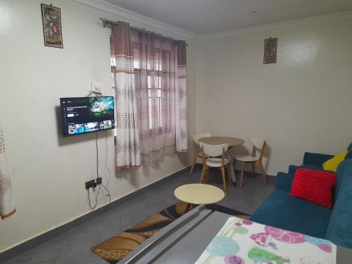 a living room with a couch and a table at City View Apartment, Albert Cook Road in Kampala