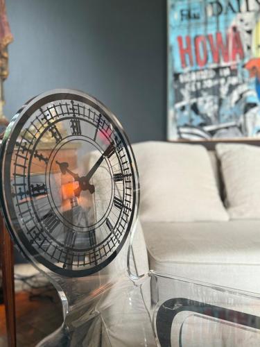a clock sitting on top of a glass table at VILLA AUTHENTIQUE A 2 pas de la mer in Knokke-Heist