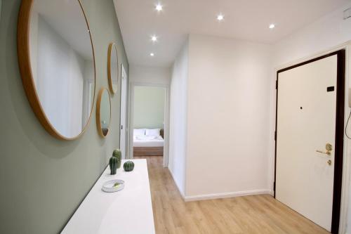 a white room with a mirror and a white hallway at HC - Charming Apartment in Vigna Clara in Rome