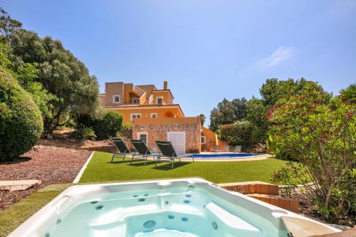 a hot tub in the yard of a house at Vivenda Vale Verde in Carvoeiro