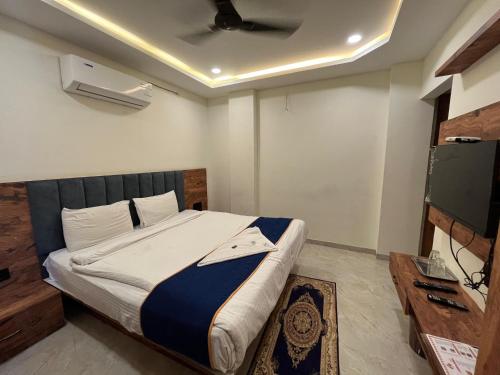 En eller flere senge i et værelse på Hotel MD Star