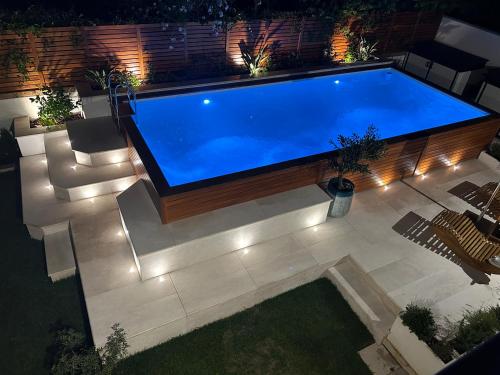 una grande piscina in un cortile con luci di Villa Rei M&M- sea view, swimming pool & Jacuzzi a Costa Rei