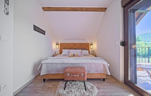 a bedroom with a bed and a large window at Villa Debelo Brdo by Villas Guide in Debelo Brdo