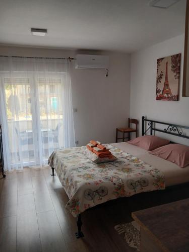 a bedroom with a bed with a blanket on it at Asi 1 i Asi 2 in Ivanica