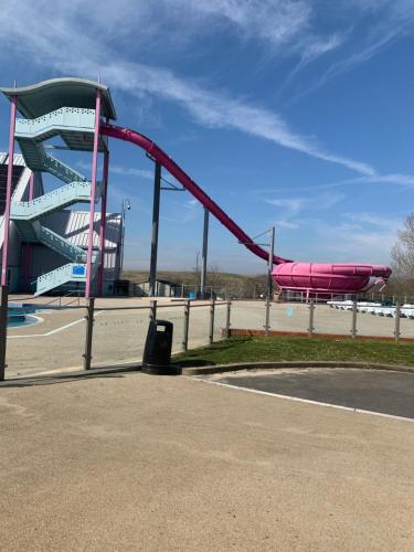 a water slide in a park with a pink slide at Beautiful beach themed static caravan in Hastings